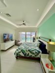Master bedroom with kign bed and full bath and ocean views